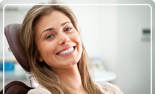 A smiling woman in a dentist's chair