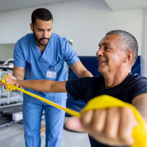 Physical Therapist working with a patient rehabilitating his arms