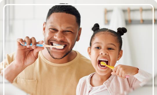 Father and Daughter brushing their teeth