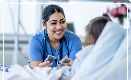 Nurse practitioner treating an accident patient in a hospital bed